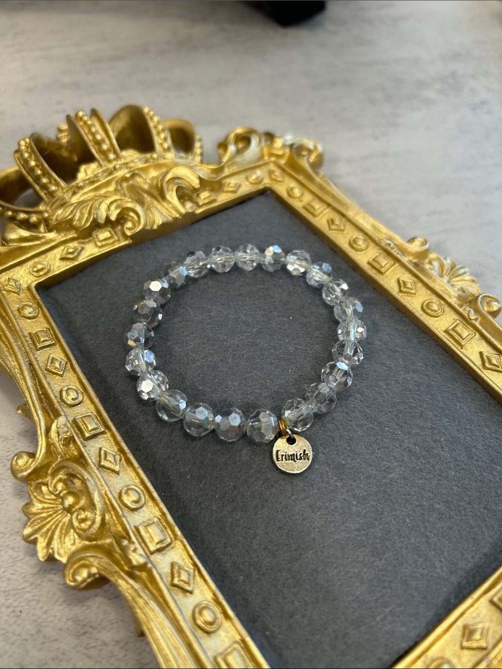 Erimish Iridescent Silverish Clear Crystal Stretch Bracelet with Logo Charm